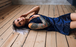 Tattooed woman laying on wooden - christen dalsgaard free wallpaper