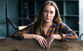 Serious woman fence plaid portrait - a wooden fence free wallpaper