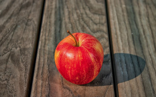 Red apple wooden table shadow 3 - a red apple free wallpaper