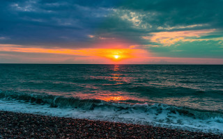 Sunset ocean waves beach person 10 - a sunset over the ocean free wallpaper