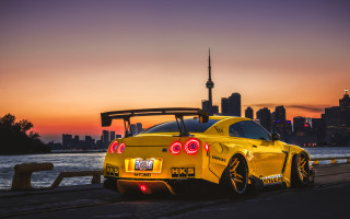 Yellow sports car road water 2 - the side of a road near a body of water free wallpaper