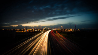 Highway night cityscape motionblur bridge - a city in the background free wallpaper