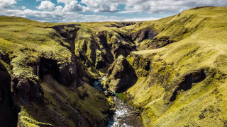 River valley mountains cloudy sky 10 - a lush green valley under a cloudy sky free wallpaper