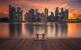 Bench pier city sunset sky - a red sky in the background free wallpaper for desktop