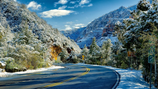 Snowy mountain road bridge forest - a curve in the middle of it free wallpaper