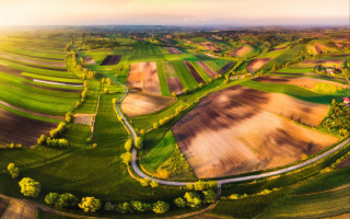 Rural countryside winding road sunset - road in the middle of it free wallpaper
