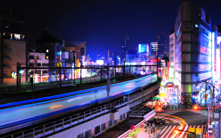 Train city night lights skyscraper - a city skyline in the background free wallpaper