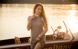 Woman boat lake sunset steering - the sun setting behind her free wallpaper