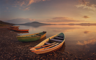 Canoes beach water sunset cityscape - top of a beach next free wallpaper