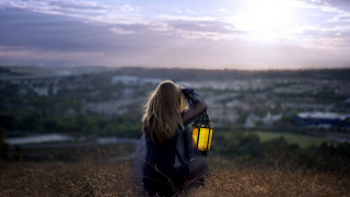 Woman field sky lantern city - her hand and a city in the background free wallpaper