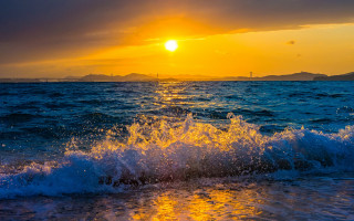 Sunset ocean wave island city - a small island in the distance free wallpaper