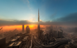 City skyline tower foggy sunset - a sun setting free wallpaper