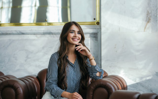 Woman sitting brown leather couch - framed free wallpaper