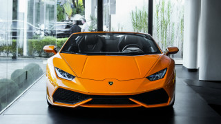 Bright orange sports car showroom 3 - a man in the background free wallpaper