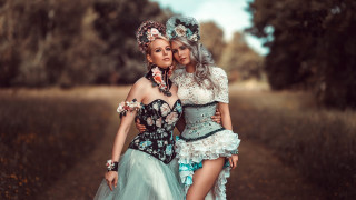 Two women costumes field hugging - costume free wallpaper