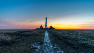 Lighthouse sunset grassy field tilt - a grassy field free wallpaper