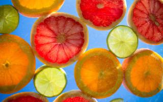 Citrus fruit slices blue surface - christian w. staudinger free wallpaper