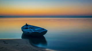 Small boat lake sunset reflection - top of a lake free wallpaper
