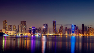 City skyline lake boat night - a matte painting free wallpaper