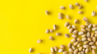 Nuts pile yellow background green - product photography free wallpaper for desktop