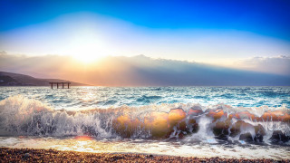 Beach waves pier sunset ocean - a bright sun in the sky free wallpaper