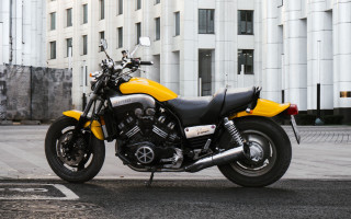Yellow motorcycle road building futurism - a computer rendering free wallpaper