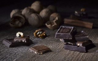 Chocolate nuts pile wooden table - clara peeters free wallpaper