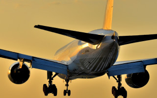 Jetliner cloudy sky sunset backlit - its landing free wallpaper