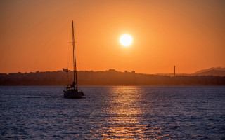 Sailboat sunset cityscape moon water - a sailboat free wallpaper