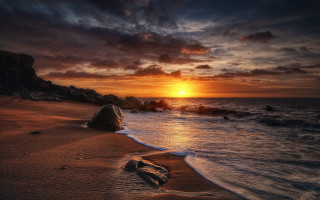 Sunset beach rock watercity sky - a sunset over a beach free wallpaper