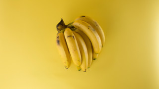Bananas yellow background black stem - ripe free wallpaper