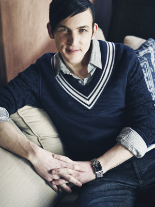 Man sitting couch sweater smile - a portrait free wallpaper