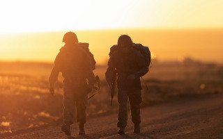 Soldiers dirt road sunset backlit - a dirt road free wallpaper