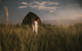 Woman dress field rock clouds - tall grass free wallpaper