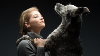 Woman dog portrait blackbackground blonde - a black background behind her free wallpaper
