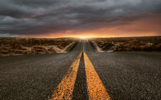 Long straight road yellow line - a dark sky in the background free wallpaper