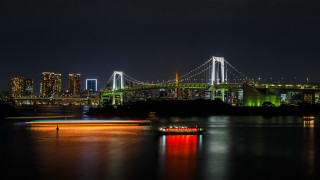 Boat bridge city night holography - a city in the background and a boat free wallpaper