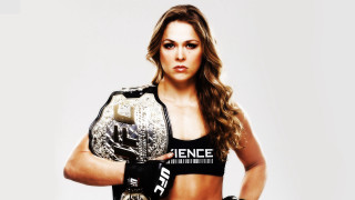 Woman black wrestling outfit holding - a white background behind her free wallpaper
