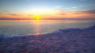 Sunset river beach clouds lens - a sunset over a body of water free wallpaper