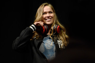 Woman headphones smiling camera dark - headphone free wallpaper