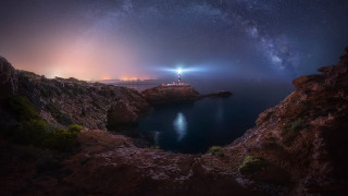 Lighthouse rocky cliff night sky - a rocky cliff free wallpaper