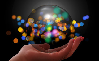Hand glass ball blurry lights - free light wallpaper
