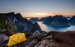 Yellow tent rocky hill sunset - a body of water and mountains free wallpaper