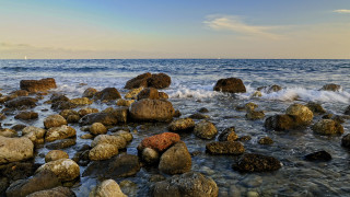 Rocky beach boat water horizon - a rocky beach free wallpaper