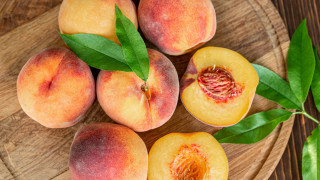Wooden plate peaches leaves summer - top of a table next free wallpaper