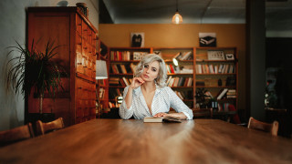 Woman book sitting portrait bookcase - a book in her hand and a book in her other hand free wallpaper