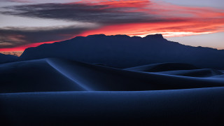 Sunset mountain range red sky 5 - a sunset over a mountain range free wallpaper