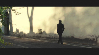 Man in suit walking building - a white wall free wallpaper