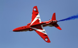 Red jet blue smoke aircraft - a blue sky behind free wallpaper