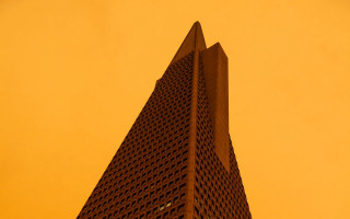 Tall building clock yellow sky - dystopian free wallpaper